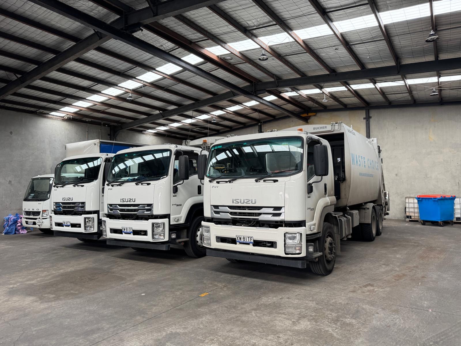 Waste Choice fleet of trucks in warehouse